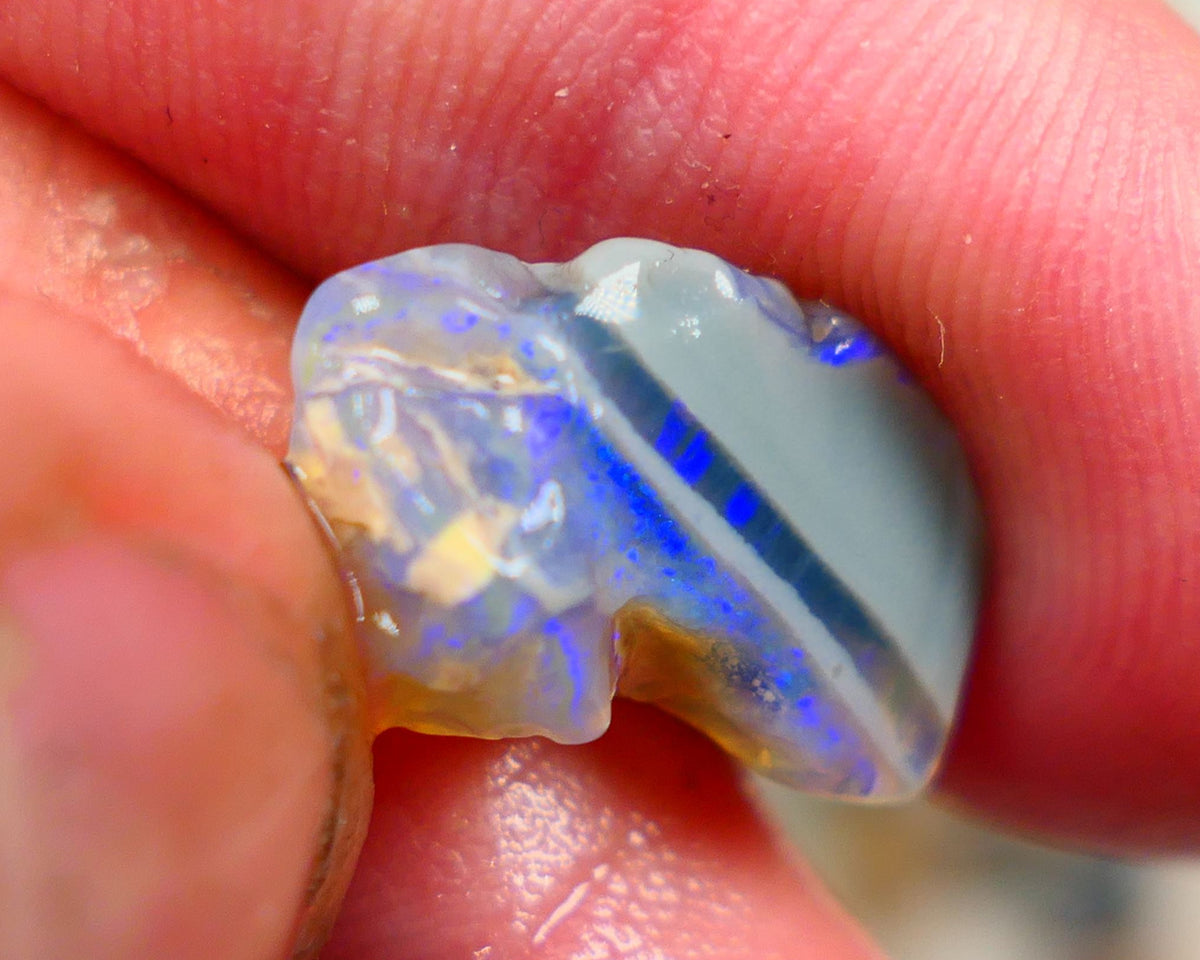 Lightning Ridge Rough Opal 6.00cts Crystal opal carrying fire sat on a bar with blues sat on dark base mother nature hey? Sold as gamble 17x10x7mm Auciton168