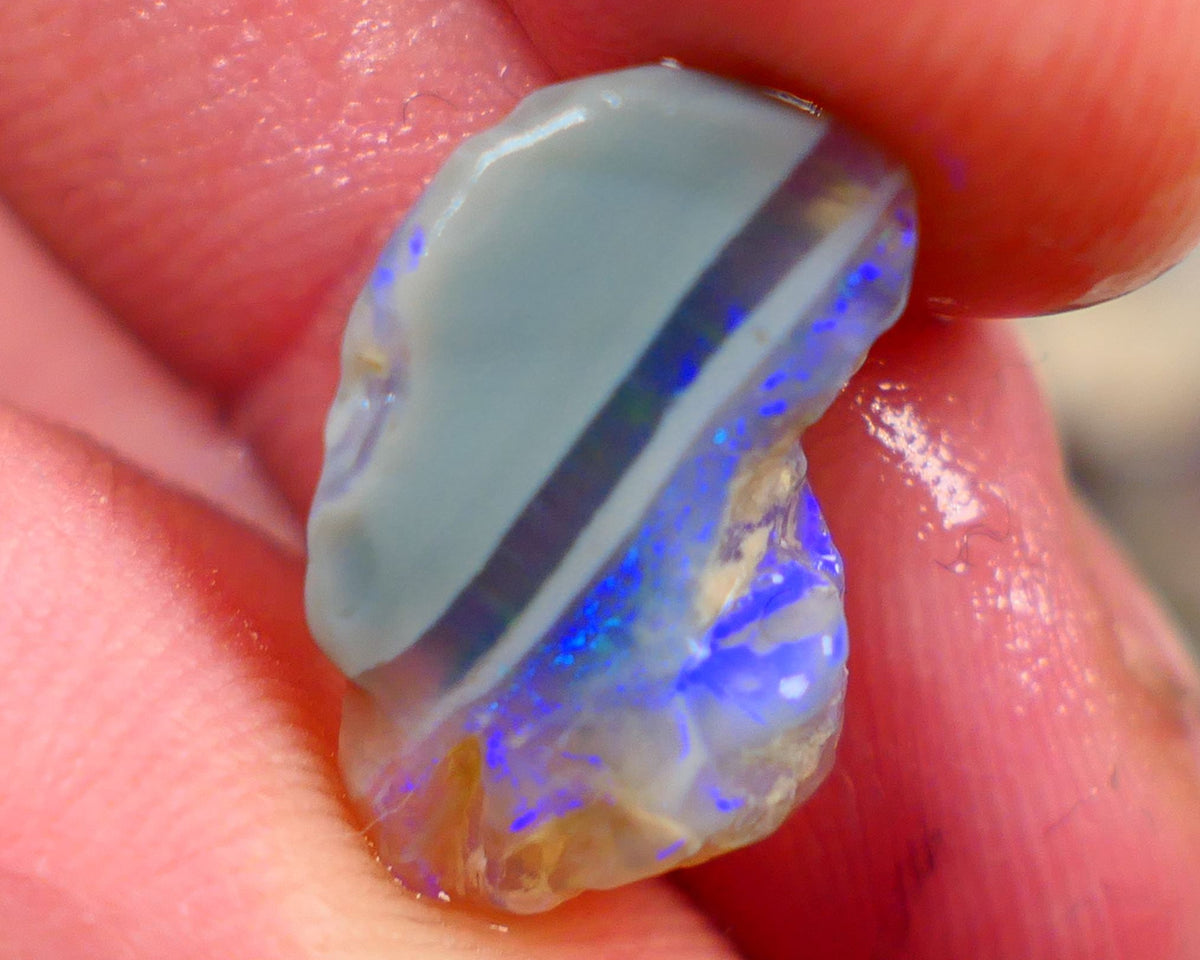 Lightning Ridge Rough Opal 6.00cts Crystal opal carrying fire sat on a bar with blues sat on dark base mother nature hey? Sold as gamble 17x10x7mm Auciton168